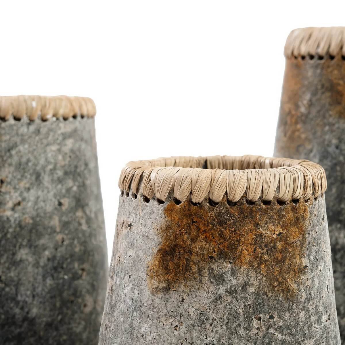 Close-up of De stiekeme vaas - antiek grijs - s with terracotta finish and raffia detail, perfect for dried and fresh flowers.