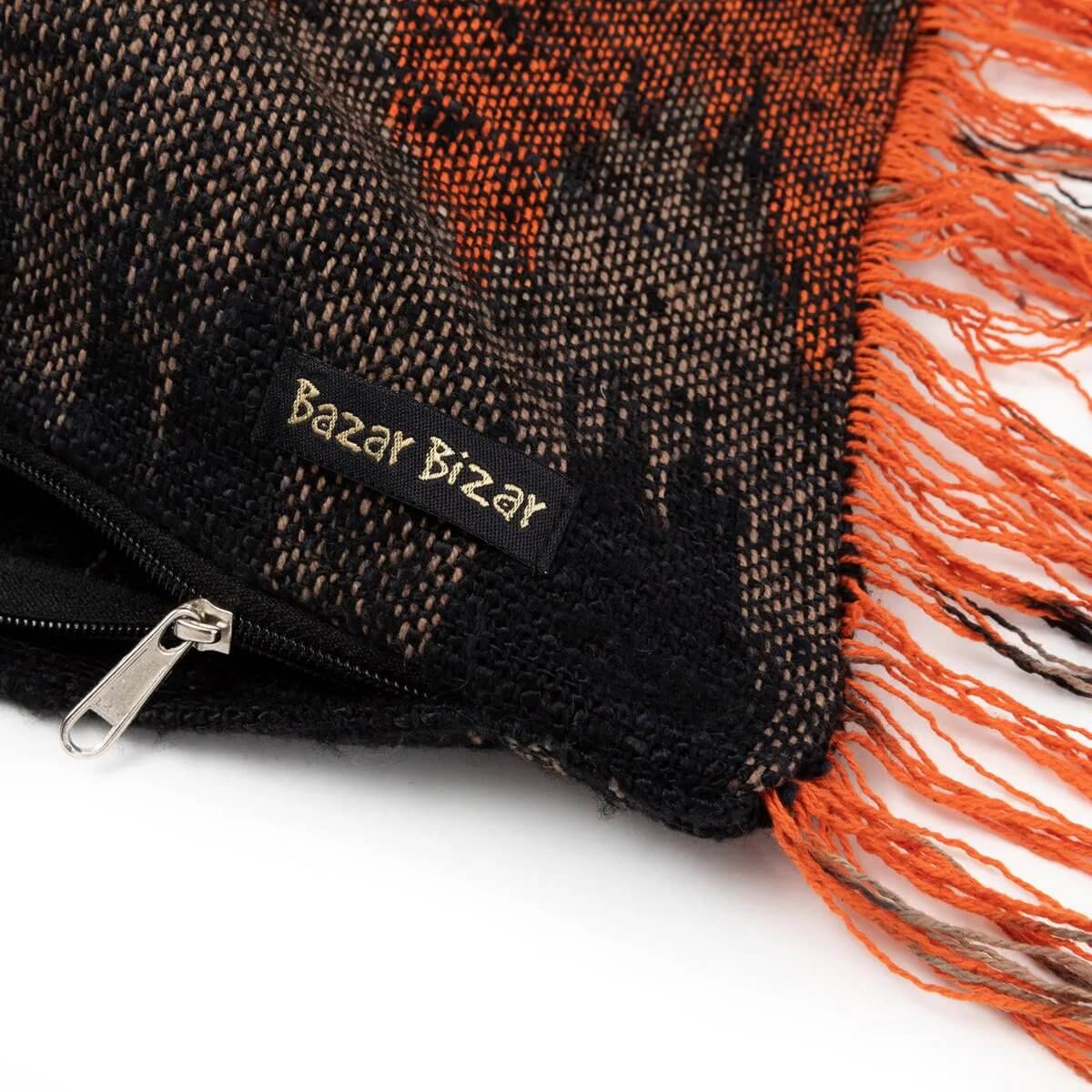Detail of The Oh My Gee Kussenhoes - Zwart Oranje - 35x100 with fringe and zipper, ideal for boho decor.